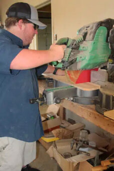 Josh Hass working with drywall