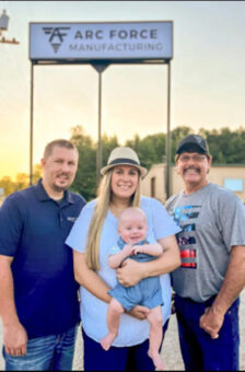 Moffett family standing in front of Arc Force sign outside